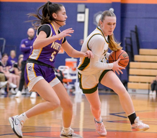 Waubonsie Valley's Hannah Laub (2) drives past Downers Grove North's Campbell Thulin (5) during the Class 4A Oswego Sectional semifinal basketball game on Tuesday, Feb. 20, 2024. (Mark Black / Naperville Sun)