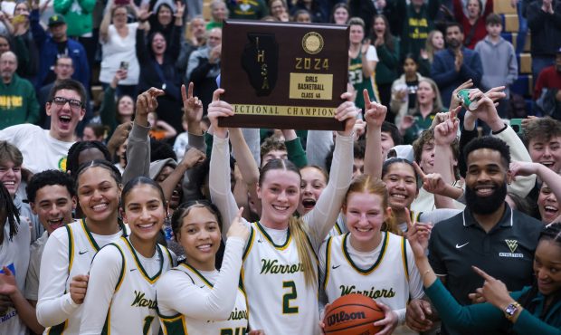 The Waubonsie Valley girls Basketball team celebrates winning the Class 4A Oswego Sectional championship game against Benet Academy on Thursday, Feb. 22 2024. (Troy Stolt for the Naperville Sun)