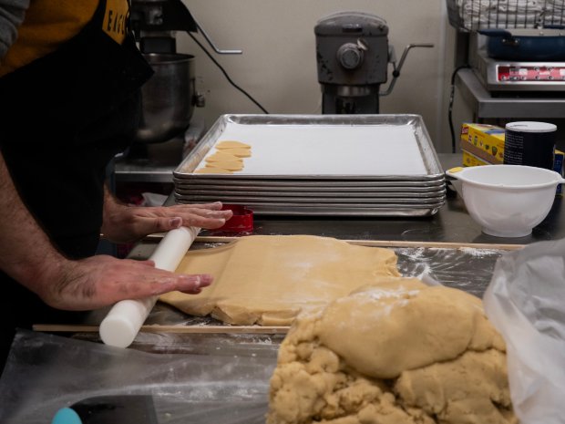 Nicholas Thibault rolls out cookie dough at Moose & Me Baking Company's storefront at 3075 Book Rd. in Naperville on Feb. 6, 2024. (Tess Kenny/Naperville Sun)