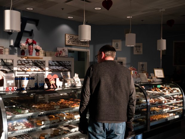 A customer looks at a selection of paczkis at Fiene's Bakery in Naperville on Friday, Feb. 9, 2024. (Tess Kenny/Naperville Sun)