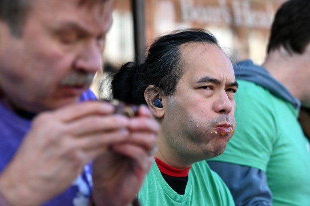 From left to right, are future first place winners Frank Wach of Norwood Park and Teddy Delacruz of Wood Dale at the annual Paczki Eating Contest at Bennison's Bakery in Evanston on Feb. 10, 2024.