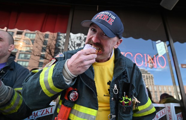 Evanston Fire Captain Kevin Roche competes in the annual Paczki Eating Contest at Bennison's Bakery in Evanston on Feb. 10, 2024.