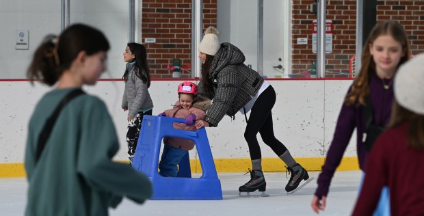 Learning to skate with her mother Jacquie Phillips of Winnetka is Sloane Phillips, 3, during Subzero Shenanigans at the Weinberg Family Recreation Center on Feb. 19, 2024 in Glencoe. Karie Angell Luc for Pioneer Press