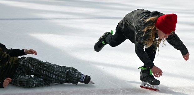 Right, in red hat, Calvin Simon, 10, fifth-grader from Glencoe, plays ice tag and recovers from a near tumble during Subzero Shenanigans at the Weinberg Family Recreation Center on Feb. 19, 2024 in Glencoe. Karie Angell Luc for Pioneer Press