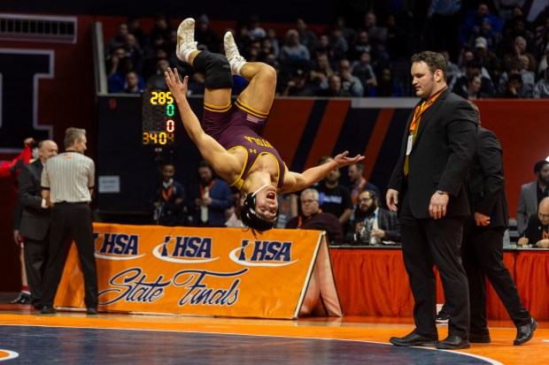 Loyola's Kai Calcutt does a back flip after defeating Marmion's Joseph Favia in the 215 pound bout in the class 3A state wrestling championship at the State Farm Center at University of Illinois in Champaign on Saturday, Feb. 17, 2024. (Vincent D. Johnson / Daily Southtown).