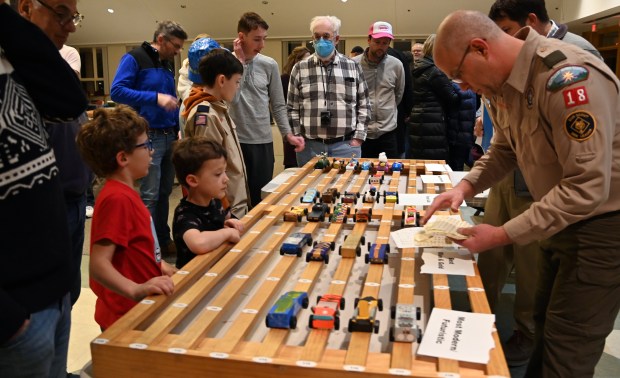 Far right, Khalid Ghantous of Winnetka, Cubmaster of Cub Scout Pack 18, checks on cars before racing at the Cub Scout Pack 18 Pinewood Derby on Jan. 31, 2024 in Winnetka at Winnetka Presbyterian Church (1255 Willow Road).