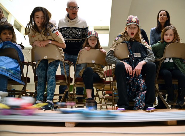 First row, from second left to right, are Den 5 Scouts, all from Winnetka, Emme McDill, 11, a fifth-grader, Tatum McCauley, 10, a fifth-grader and Clara Lang, 11, a fifth-grader at the Cub Scout Pack 18 Pinewood Derby on Jan. 31, 2024 in Winnetka at Winnetka Presbyterian Church (1255 Willow Road).