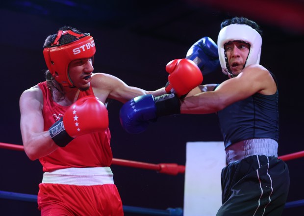 Isiah Steeno, left, spars with Jack Abarca, right, in the 140 pound bout during "Fight Night" Feb. 16, 2024 at the Elmwood Park Parks and Recreation Center in Elmwood Park. (Trent Sprague/Pioneer Press)