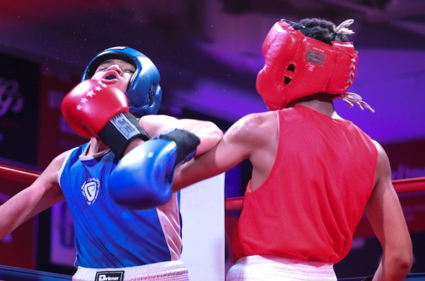 Sweat flys off the face of Ricardo Aguilera, left, after being punched by Yahandry Laguma, right, in the 126 pound bout during "Fight Night" Feb. 16, 2024 at the Elmwood Park Parks and Recreation Center in Elmwood Park. (Trent Sprague/Pioneer Press)