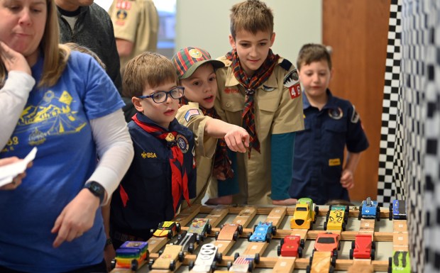 Second from left, first row, is Ben Giannini, 7, a second-grader from Northbrook where cars are being staged to roll later at the Pinewood Derby at Westminster Hall at the Village Church of Northbrook on Feb. 17, 2024 in Northbrook. Karie Angell Luc for Pioneer Press.