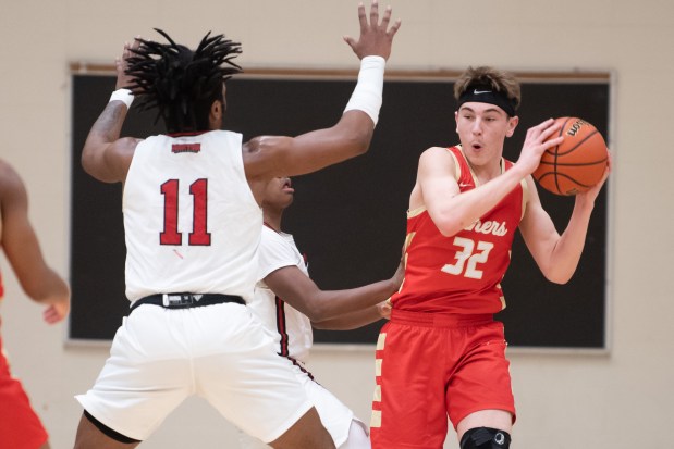 Andrean's Paul Gilvydis tries to pass under pressure by Morton's Jeremiah Moore on Thursday, January 19, 2023. (Kyle Telechan for the Post-Tribune)