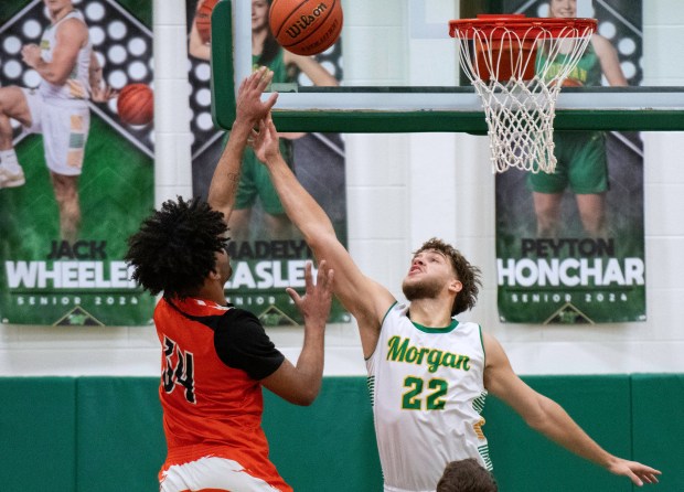 Morgan Township's Hayden Grieger attempts to block a shot from Westville's Kaden Pepper during a game at Morgan Township on Friday, Feb. 16, 2024. (Michael Gard/Post-Tribune)