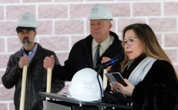 Eva Gomez, President Drexel Foundation, (right) leads the crowd in prayer during a groundbreaking ceremony on a $8 million addition to the Thea Bowman Leadership Academy in Gary on Feb. 3, 2024. The addition will be a two-story eight classroom building for elementary students. There will also be a multipurpose room for athletics and arts, a health clinic, new athletic fields with a track and football field and a maintenance building.