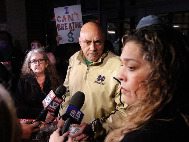 East Chicago Councilman Robert Garcia, D-1st, (center) and Councilwoman Monica Gonzalez, D-5th, (right) answer questions from the press outside East Chicago Central High School. Residents were stopped at the doors of the high school for a scheduled public hearing on the renewal of the BP Whiting refinery air permit on February 8, 2024. (John Smierciak/Post-Tribune)