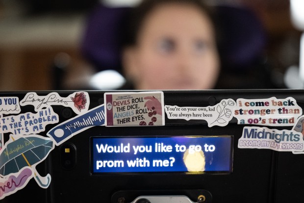 Crown Point resident Sophia Burns, who has Rett Syndrome, practices a prom proposal with her speech language pathologist, Adrian Herrenbruck, during a speech therapy session on Thursday, January 25, 2024. (Kyle Telechan for the Post-Tribune)