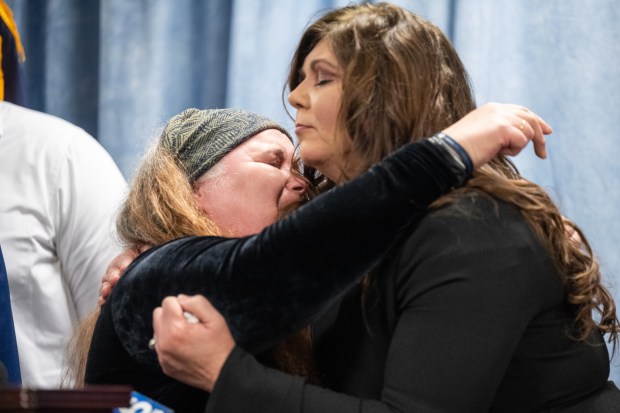 Ollie Hubbard, whose daughter, Lauren Calvillo, was killed in a 2015 shooting, on right, leans in to hug Penny Robinson, whose brother, Christopher White, was paralyzed in the shooting and subsequently succumbed to his injuries, as they speak during a press conference to announce the sentence given to Latin Counts member Eduardo Luciano on Wednesday, February 7, 2024. (Kyle Telechan for the Post-Tribune)