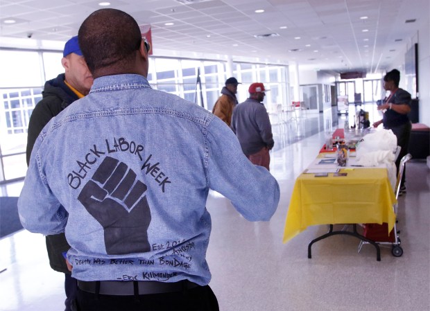 Ephrin Jenkins, Founder, Black Labor Week Project Moderator, (back to camera) talks with workers as they arrive during Black Labor Week discussion. Black mayors in Indiana discussed labor issues at IU Northwest on Wednesday, February 21, 2024. (John Smierciak/Post Tribune)