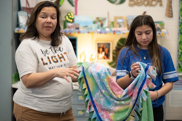 Dre's Joymakers founder Aundrea Munoz, 16, on right, and her mother, Elizabeth Munoz, instruct Joan Martin Elementary fifth-graders as they gather to finish blankets to be donated to Project Linus on Monday, February 12, 2024. (Kyle Telechan for the Post-Tribune)