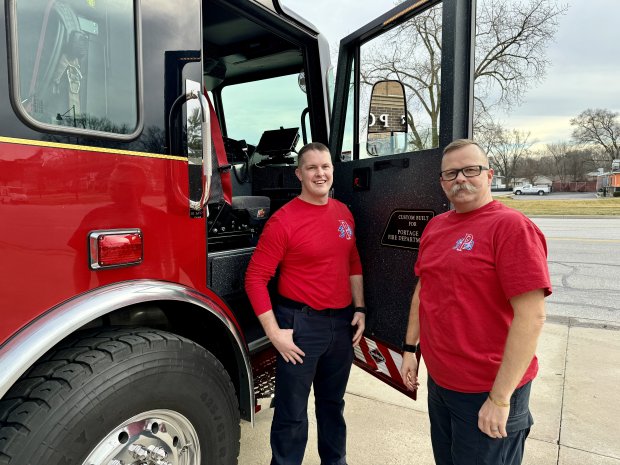 Firefighter/paramedic Jordan Bucy and Captain Andy Himan show the Portage Fire Department's new fire engine, which cost nearly $1 million. Much of the equipment on it was transferred from an existing engine. The battery-operated rescue equipment on it is new. (Doug Ross/For Post-Tribune)