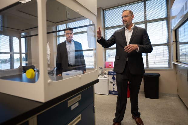 Neurodon CEO Russell Dahl, on right, points out equipment in the company's lab to US Senator Todd Young (R-IN) during a walkthrough of the facility on Thursday, Februrary 15, 2024. (Kyle Telechan for the Post-Tribune)