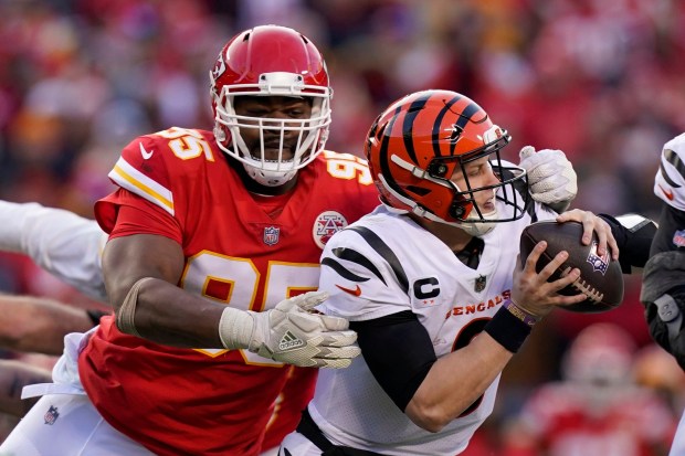 Cincinnati Bengals quarterback Joe Burrow (9) breaks a tackle attempt by Kansas City Chiefs defensive end Chris Jones (95) during the second half of the AFC championship NFL football game, Sunday, Jan. 30, 2022, in Kansas City, Mo. (AP Photo/Eric Gay)