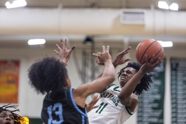 Evergreen Park's Keshaun Crawl-Vaval (11) puts up a fadeaway against Hillcrest during the Class 3A Evergreen Park Regional final in Evergreen Park on Friday, Feb. 23, 2024. (Vincent D. Johnson / Daily Southtown)