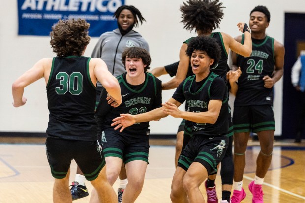 Evergreen Park's F Billy Buchanan (30) is greeted by Grady Elwood and Ulises Cardenas after a Hillcrest game-winning shot falls short at the buzzer during a South Suburban Conference crossover in Country Club Hills on Friday, Feb. 2, 2024. (Vincent D. Johnson / Daily Southtown).