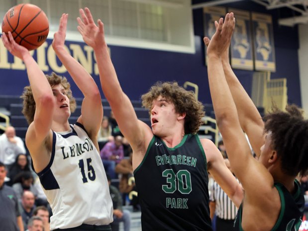 Evergreen Park's Billy Buchanan (30) defends as Lemont's Shea Glotzbach shoots during the basketball game in Lemont, Tuesday, February 6, 2024. (James C. Svehla-Daily Southtown)User Upload Caption: Tk