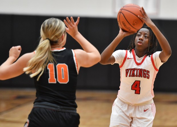 Homewood-Flossmoor's Jenesis Moore (4) shoots as Lincoln-Way West's Molly Finn (10) defends during their Class 4A Lincoln-Way West Regional final game in New Lenox on Thursday, February 15, 2024.(Jon Cunningham for the Daily Southtown)