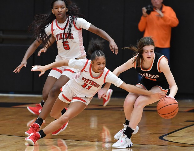 Homewood-Flossmoor's Layla Pierce (11) tries to steal the ball from Lincoln-Way West's Mackenzie Roesner during their Class 4A Lincoln-Way West Regional final game in New Lenox on Thursday, February 15, 2024.(Jon Cunningham for the Daily Southtown)