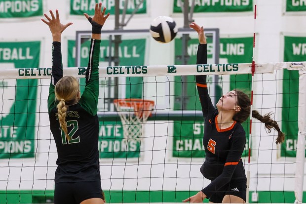 Lincoln-Way West's Caroline Smith spikes the ball as Providence Catholic's Payton Mandac defends during a game in New Lenox on Tuesday, Aug. 26, 2023. (Troy Stolt for the Daily Southtown)