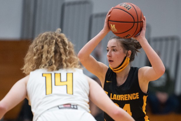 St. Laurence guard Claire Allison looks to pass past Marian Catholic forward Anna Kleszynski on Tuesday, December 21, 2021. (Kyle Telechan for the Daily Southtown)