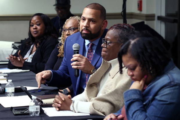 Dolton Trustee Jason House, holding microphone, speaks a public meeting Feb. 22, 2024, in a Dolton Park District building. (Terrence Antonio James/Chicago Tribune)