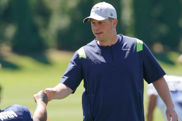 Seahawks offensive coordinator Shane Waldron greets players at practice on Aug. 3, 2022.