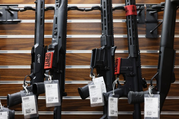 A display case holds an assortment of rifles at Accuracy Firearms in Effingham on Jan. 26, 2023, that cannot be sold to customers because of recent state firearms legislation that bans the sale and distribution of assault weapons and high-capacity magazines.