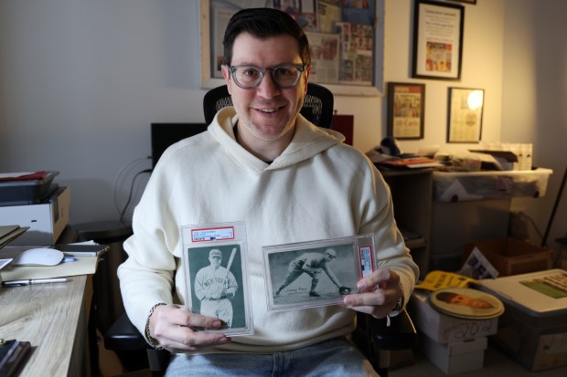Sports memorabilia expert Michael Osacky with Babe Ruth and Jimmy Foxx cards on Jan. 25, 2024.