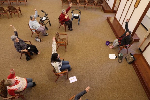 Residents participate in a chair yoga class at The Oaks of Bartlett on Jan. 26, 2024. The facility filed for bankruptcy in 2019 and now had to delay making its debt payments which is likely to impact residents' refundable entrance fees. (Stacey Wescott/Chicago Tribune)