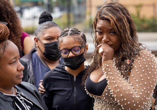 Martina Standley's sister, Rain Standley, right, gathers with other family members while speaking about her sister on Tuesday, Sept. 13, 2022, on East 71st Street near South Jeffery Boulevard in South Shore at the location where she was struck by a Chicago police vehicle in November 2019. Martina Standley died in January 2022. (Brian Cassella/Chicago Tribune)