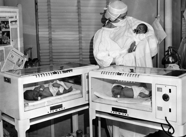 Nurse Celia Stallings holds leap year baby Larry Kosinski while yet-to-be-named newborn twins of Mr. and Mrs. Stanley Leipis sit below on Feb. 29, 1952, at Presbyterian Hospital in Chicago. Larry, whose parents are Mr. and Mrs. Lawrence Kosinski, and the twins were born on leap year day. (Frank Masters/Chicago Tribune)