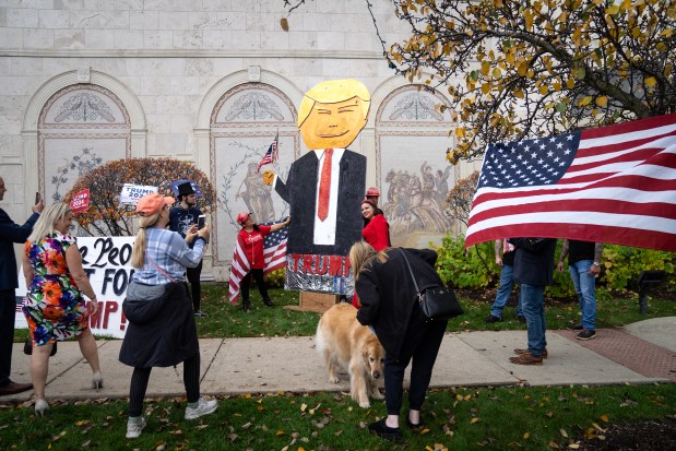 Trump supporters gather outside Venuti's Italian Restaurant and Banquet Hall in Addison after Donald Trump Jr. appeared at a McHenry County GOPAC event on Oct. 27, 2023. (E. Jason Wambsgans/Chicago Tribune)