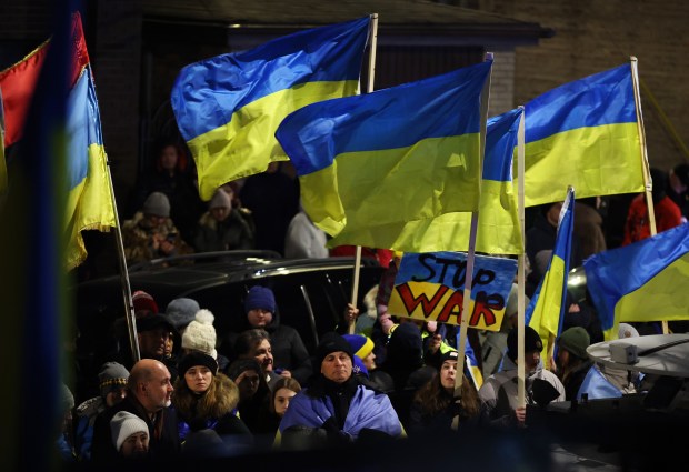 To mark the one-year anniversary of the war in Ukraine, people honor the victims and protest against the war outside of Sts. Volodymyr and Olha Ukrainian Catholic Church in Chicago's Ukrainian Village neighborhood on Feb. 24, 2023. (Chris Sweda/Chicago Tribune)