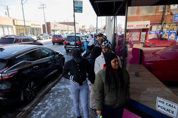 Charmaine Jackson, who got the first spot in line by showing up at 8:20 a.m. for the 11:00 a.m. opening, waits to go inside Pookie Crack Cakes on Feb. 24, 2024. (Vincent Alban/Chicago Tribune)