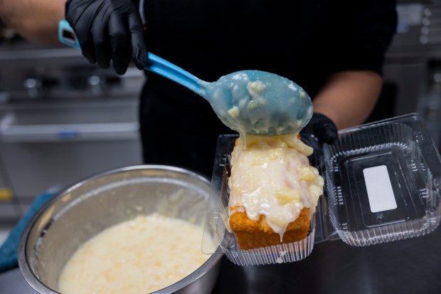 Dedra Simmons, chef and owner of Pookie Crack Cakes, prepares the pineapple paradise cake. (Vincent Alban/Chicago Tribune)