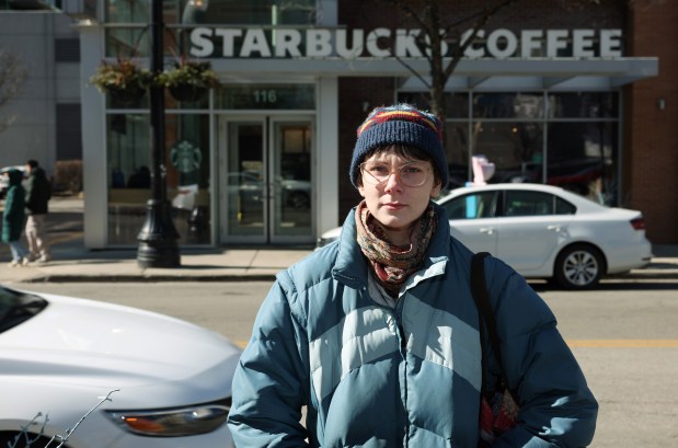 Lillie Elling, a barista at the Greektown Starbucks, outside the store where they work at 116 S. Halsted St., after their morning shift on Feb. 17, 2024. Elling and other unionized workers are filing Fair Workweek complaints against the company, alleging a lack of "good faith" work schedule estimates. (John J. Kim/Chicago Tribune)