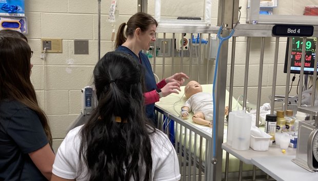 Participants in the College of Lake County's STEM for Girls program learn how to treat a manikin baby in a hospital. (Steve Sadin/Lake County News-Sun)