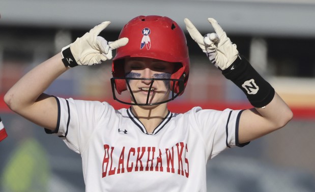 West Aurora's Katelyn Serafin (14) reacts to cheers from teammates after driving in a run with a double during a Southwest Prairie Conference game on Thursday, April 13, 2023.