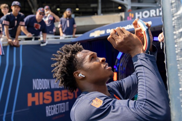 Bears wide receiver Darnell Mooney signs autographs for fans before a game against the Packers on Sept. 10, 2023, at Soldier Field. (Brian Cassella/Chicago Tribune)