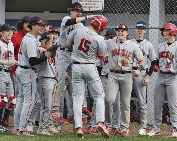 Yorkville's Nate Harris (15) is greeted by teammates after hitting a long home run against West Aurora during a Southwest Prairie Conference game in Aurora on Monday, April 24, 2023.