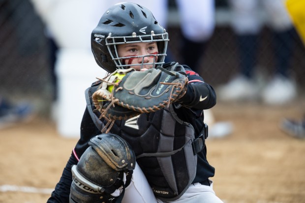 Marist catcher Caroline O'Brien (14) frames a pitch against Lemont during a nonconference game in Chicago on Wednesday, March 22, 2023.