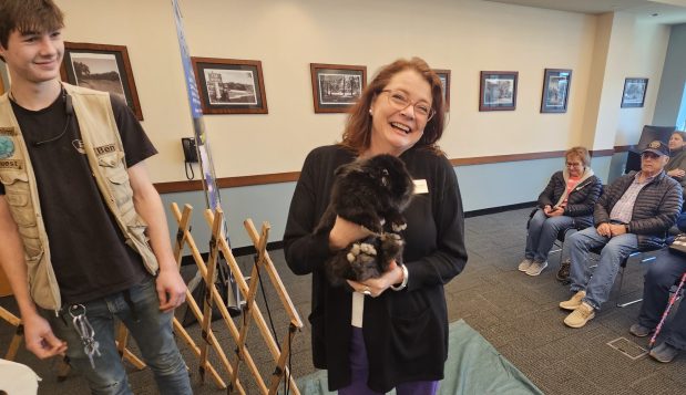 Messenger Public Library Executive Director Shannon Halikias shows off a Lionhead rabbit named Harry Saturday during the adults-only Wild World Animal Show offered by AnimalQuest at the library. (David Sharos / For The Beacon-News.